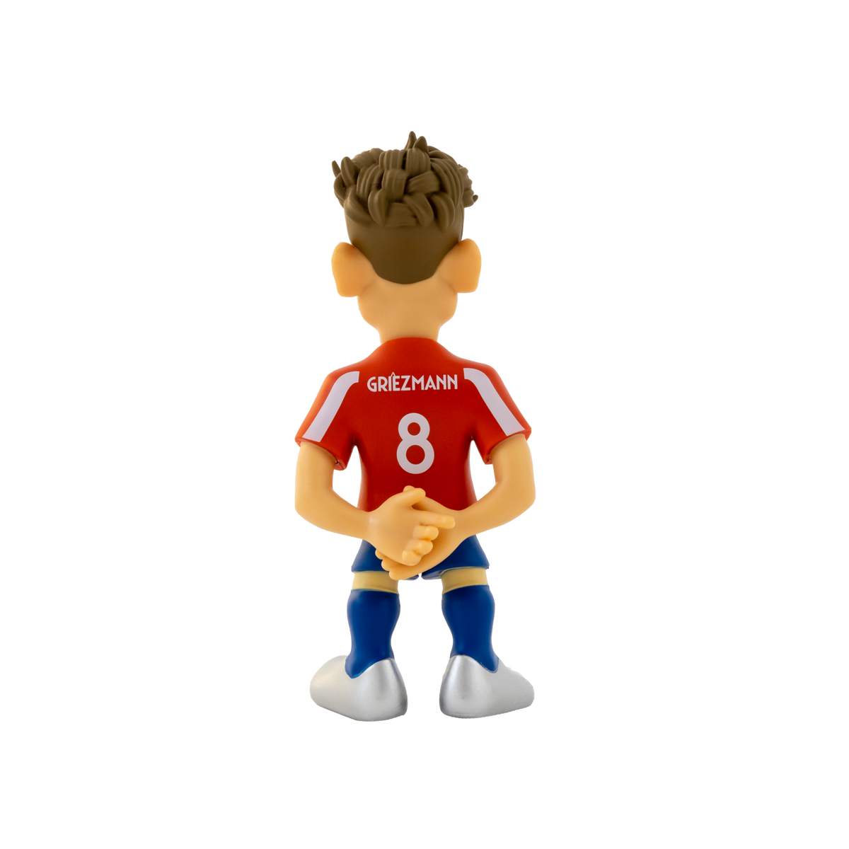 Minix Antoine Griezmann football figurine in a red shirt with white trim, blue shorts and sculpted brown hair, viewed from behind.