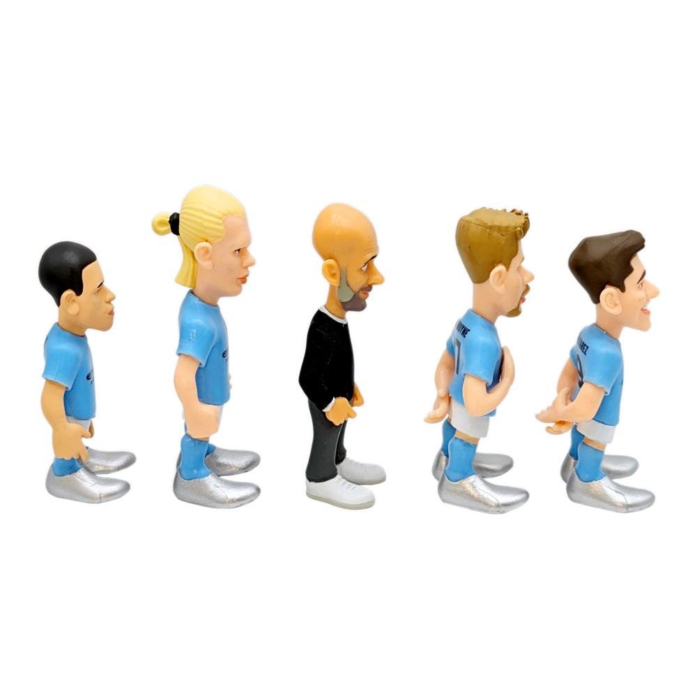 Minix Manchester City five-piece football figurine set in blue kits, with one black-clad figure and oversized heads.
