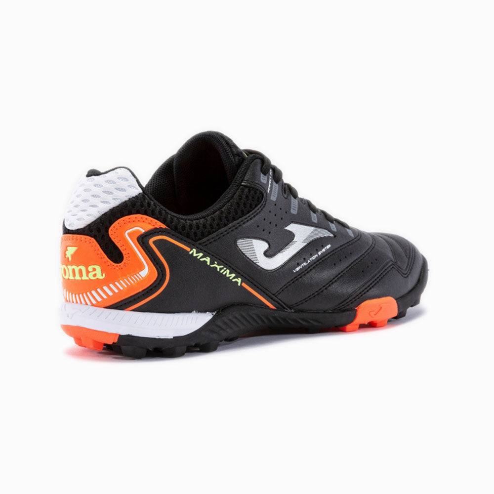 Joma Maxima Adult Turf Soccer Shoes in black with orange accents, featuring specialized studs for traction.
