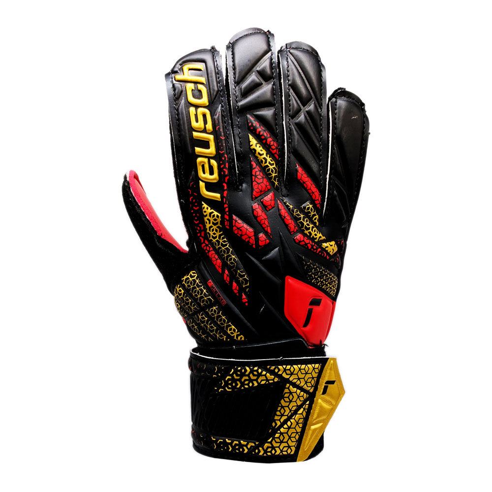 Reusch Attrakt Solid Junior Goalkeeper Gloves in black, red, and gold with expanse cut and full strap closure for flexible fit and enhanced grip.