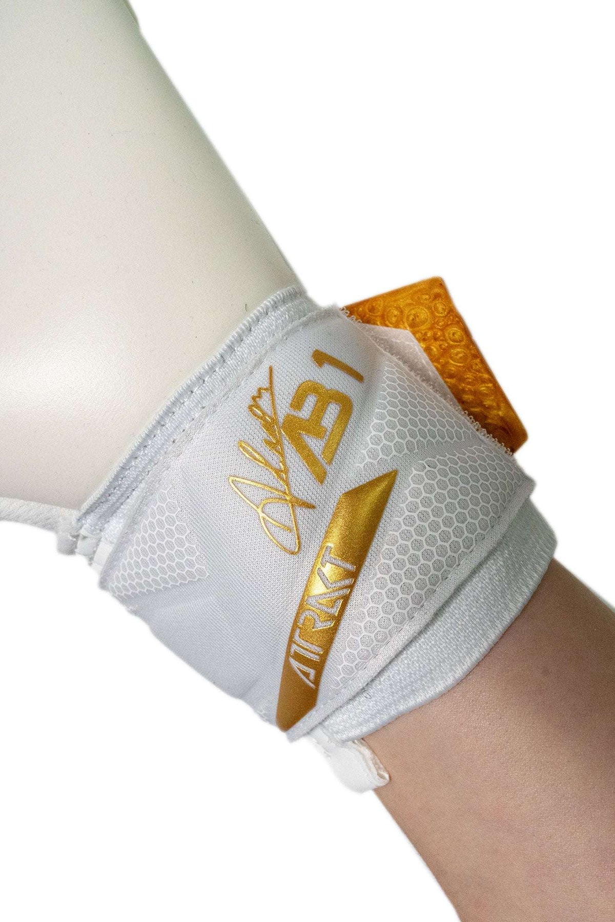 Reusch Attrakt AB1 goalkeeper glove, white textured backhand with gold branding and an adjustable wrist strap.