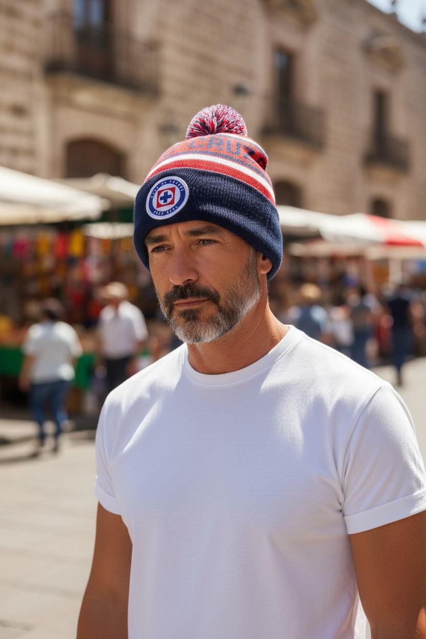 Man wearing Fan Ink unisex premium acrylic soccer club cuff hat with embroidered Cruz Azul crest and pom-pom outdoors