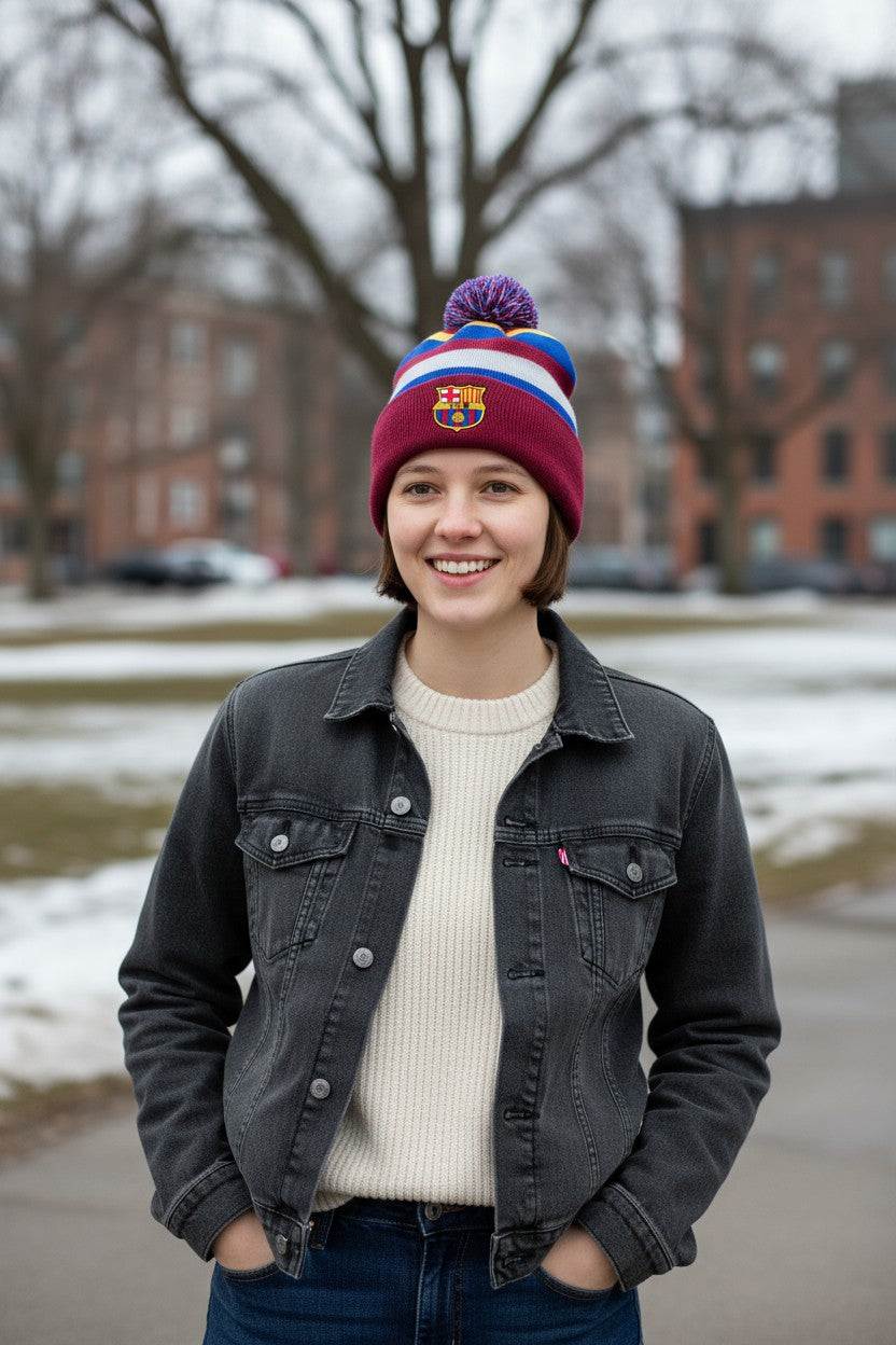 Young woman wearing Fan Ink officially licensed Barcelona Football Beanie winter hat with club crest outdoors in cold weather