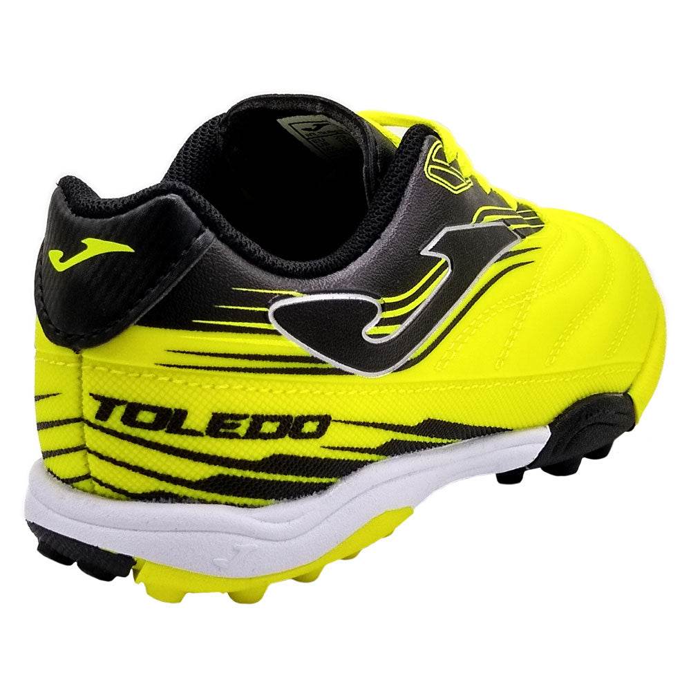 Joma Toledo Junior Turf Soccer Shoes in yellow and black with synthetic Fibertec upper and rubber outsole.