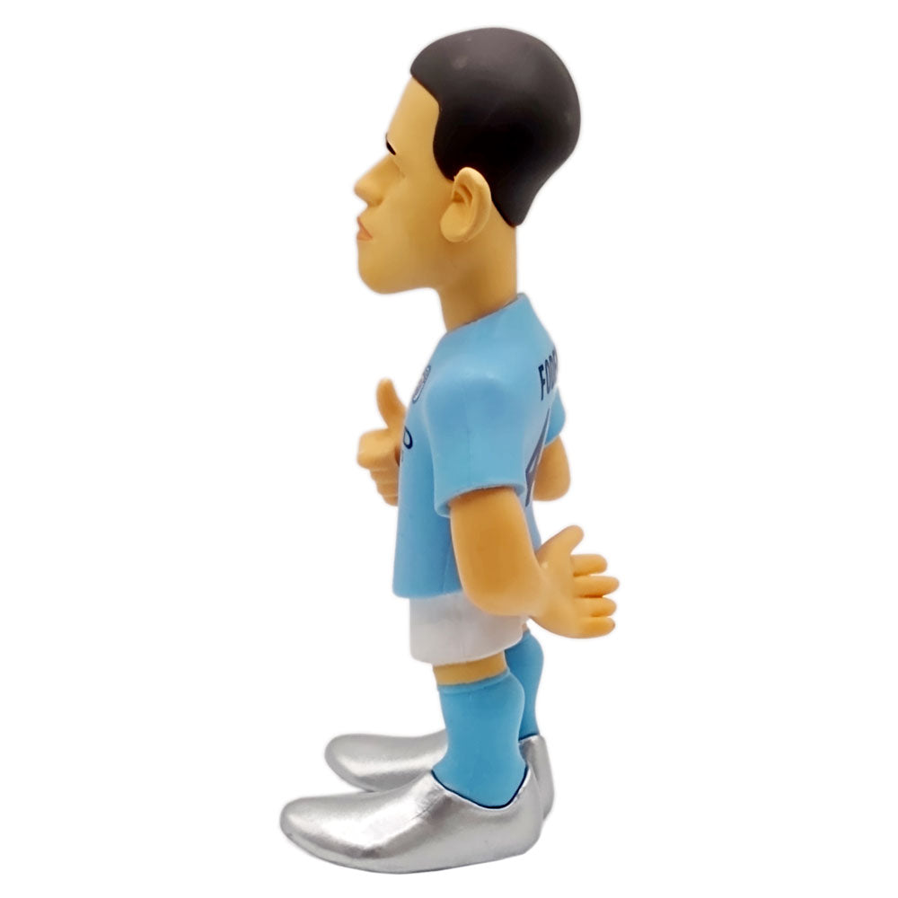 Minix Phil Foden Manchester City figurine in a sky-blue shirt, white shorts, blue socks and oversized silver boots.