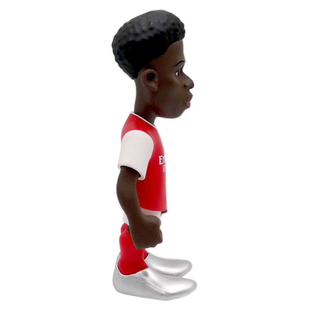 Football figurine featuring Minix Bukayo Saka Arsenal in a red and white kit, with sculpted hair and silver boots.