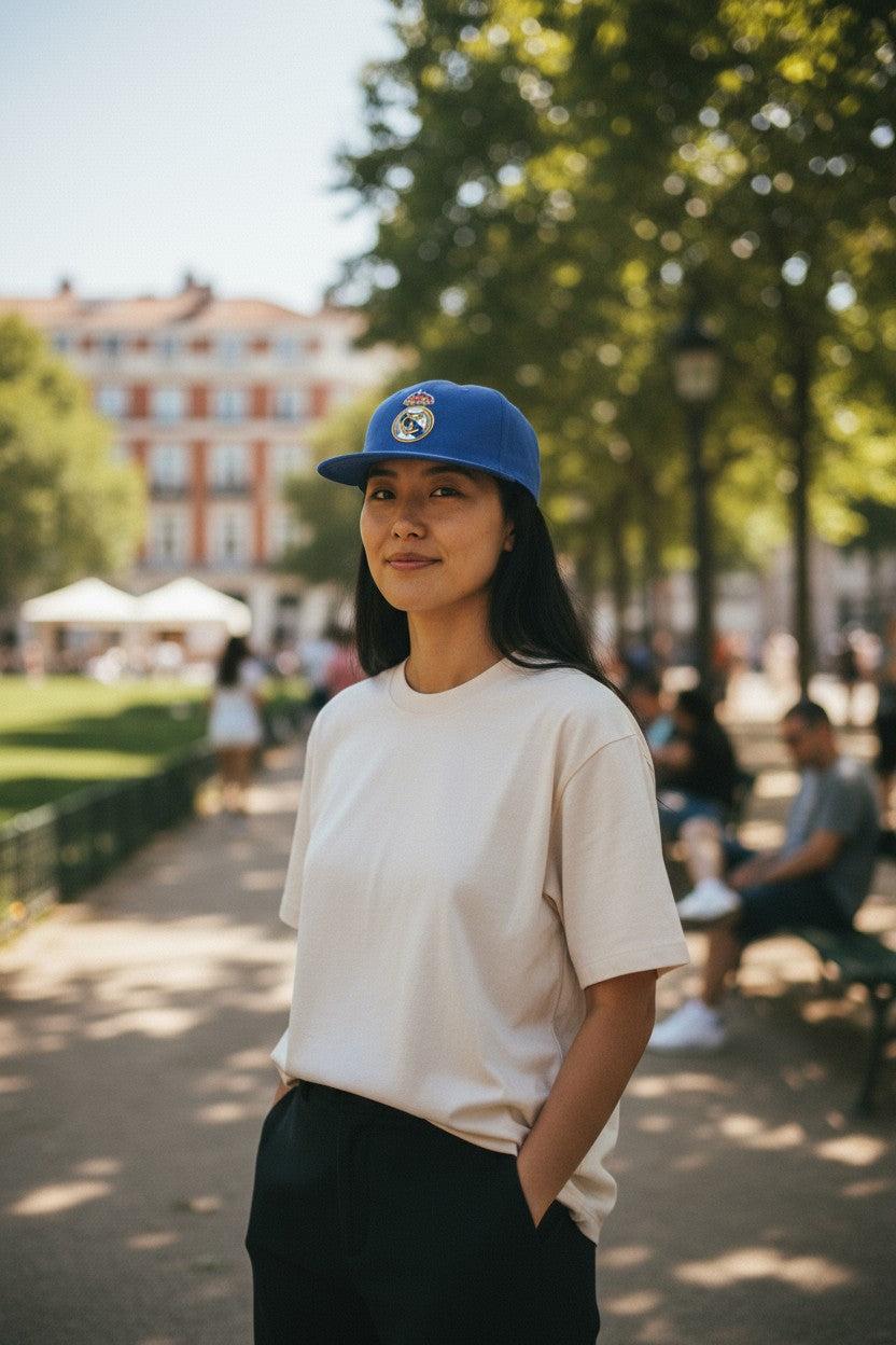 Woman wearing blue Fan Ink Officially Licensed Team Snapback Hats with Real Madrid embroidered logo outdoors