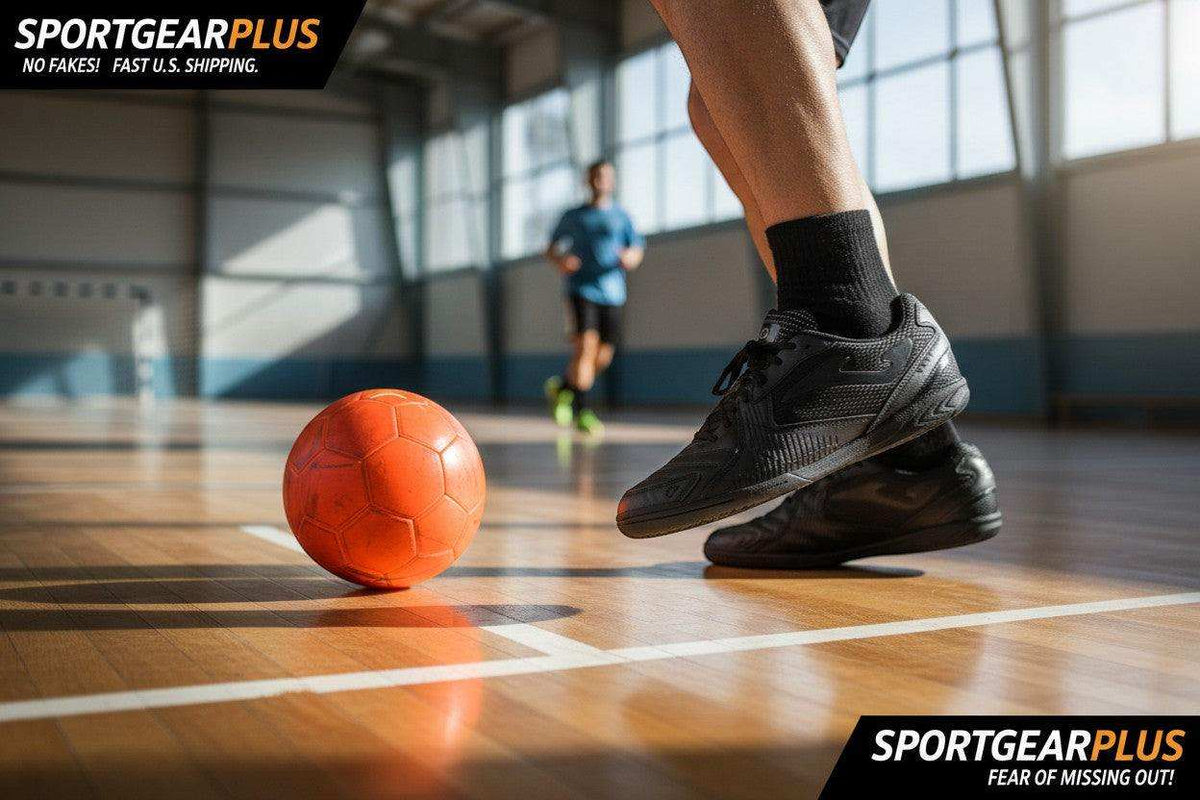 Joma Dribling indoor soccer shoes in black synthetic material, with textured uppers and flat rubber soles beside an orange futsal ball