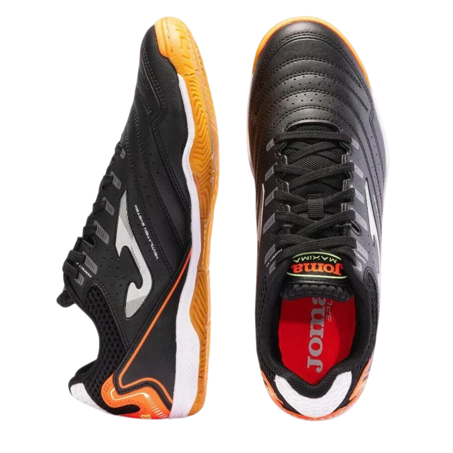 Joma Maxima indoor soccer shoes in black synthetic material, with grey accents, orange gum soles and lace-up uppers