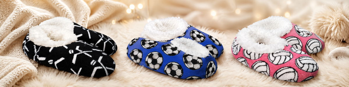 Snoozies Slippers set featuring black with white hockey sticks, blue with black and white soccer balls, and pink with white volleyballs, plush lining