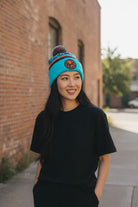 Fan Ink unisex premium acrylic soccer club cuff hat with embroidered team crest worn by woman outdoors