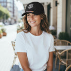 Woman wearing a black FC Barcelona Berkeley Classic Hat with felt team logo and adjustable strap buckle closure outdoors
