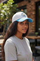 Woman wearing Fan Ink officially licensed 2-tone adjustable soccer hat with Manchester City emblem