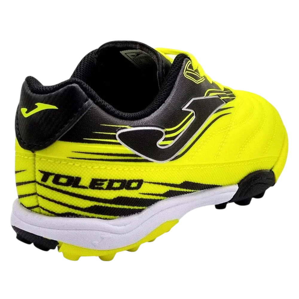 Joma Toledo turf soccer shoe in neon yellow and black with white accents, striped detailing and rubber studs.