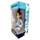 Minix Kevin De Bruyne Manchester City figurine in a sky blue kit with white boots, displayed in a clear-front box